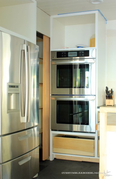 Unfinished-Pantry-Door-Open-Toward-Ovens